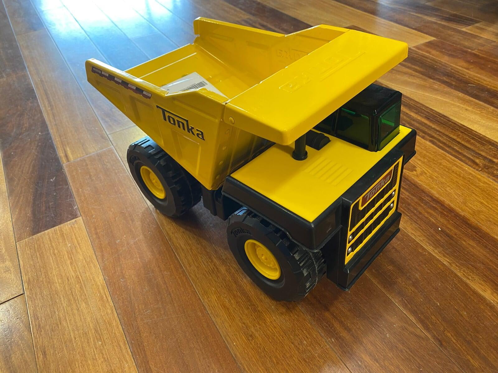 Toy yellow dump truck on a hard wood floor